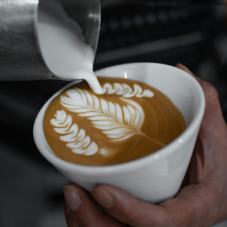 A barista pouring latte art