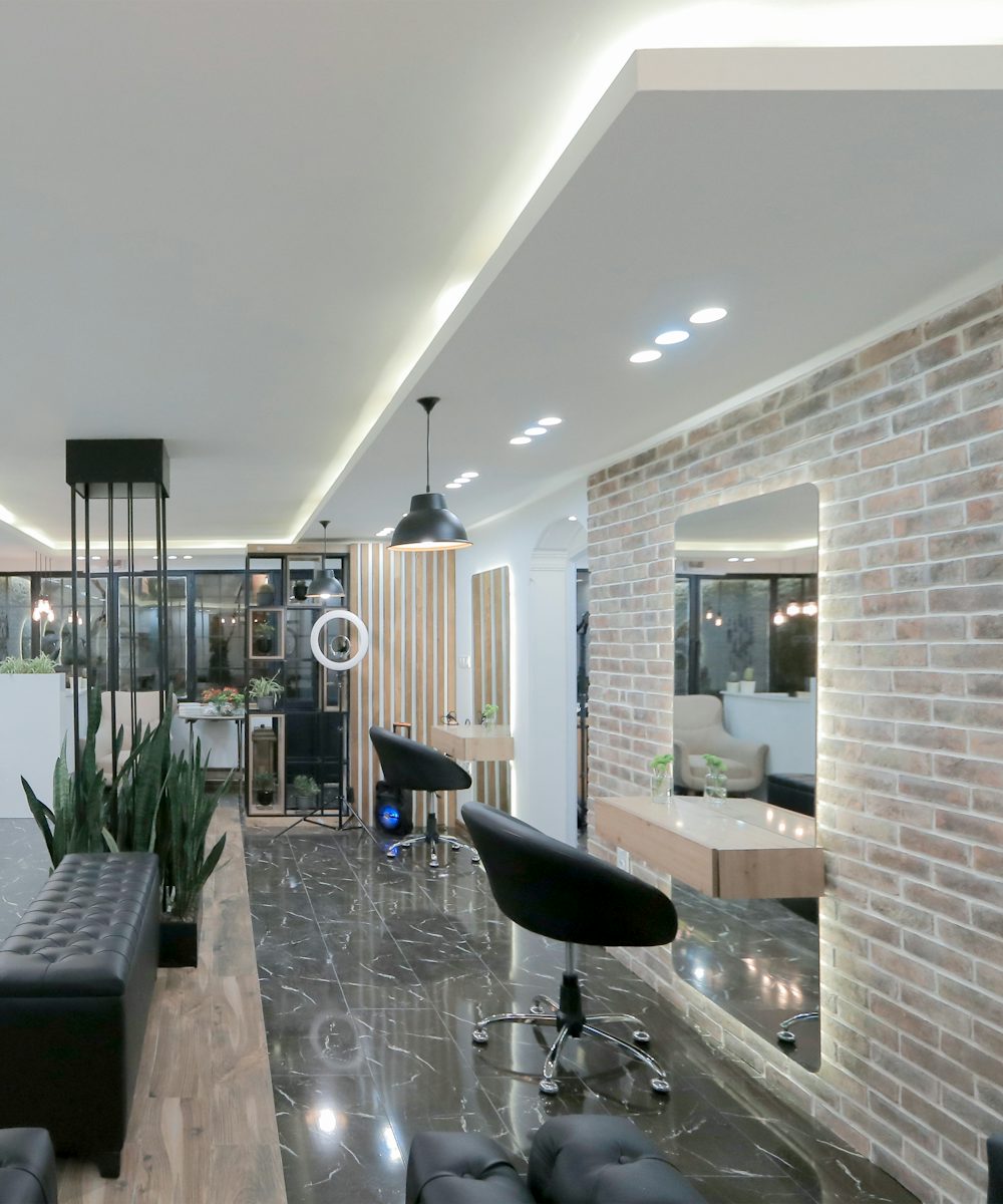 A bright, modern studio with round mirrors