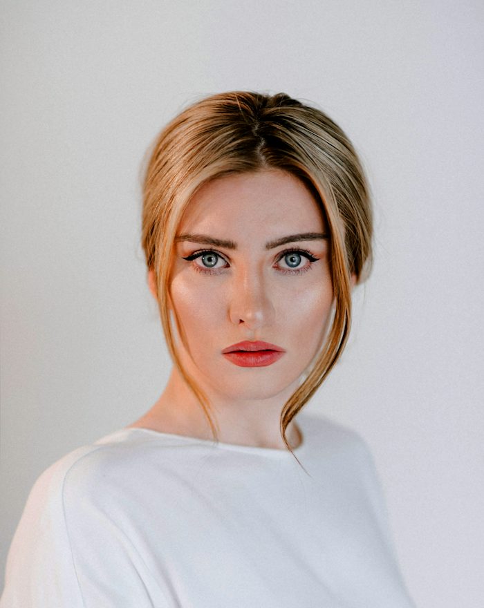 Ella, smiling in a white top