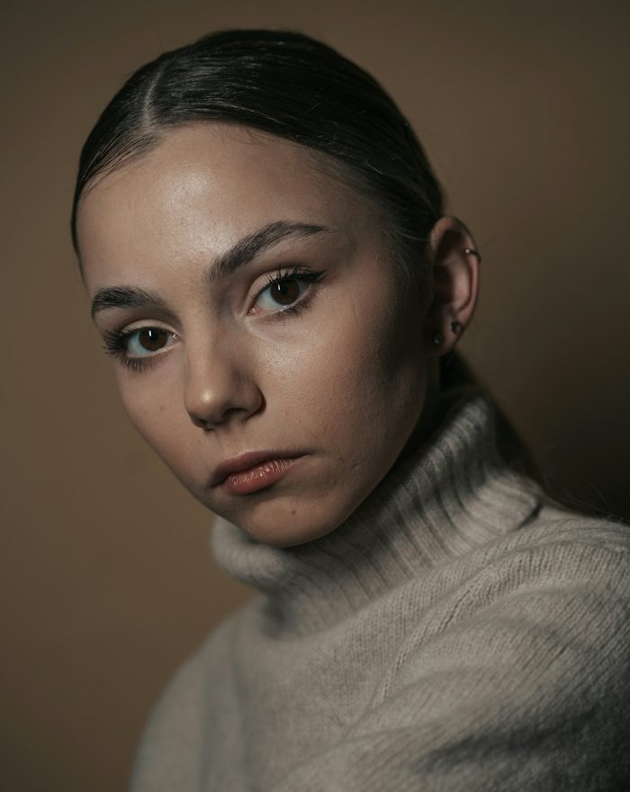 Grace in a cream turtleneck
