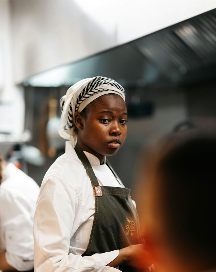 Siobhán in chef whites in a busy kitchen