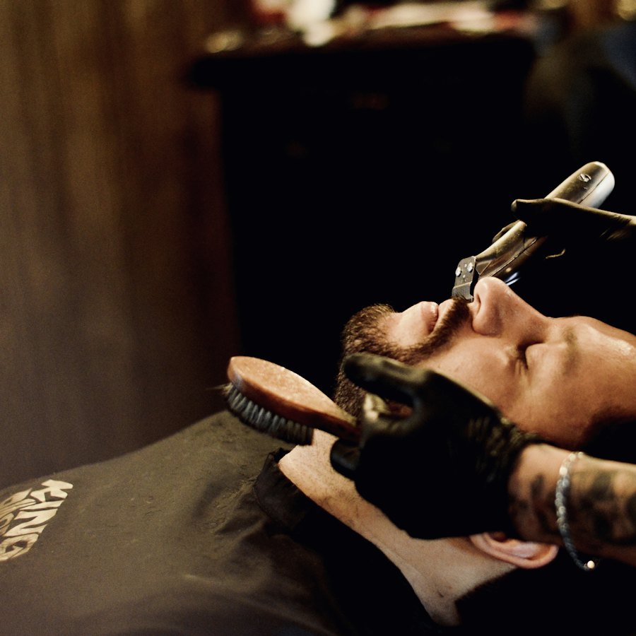 A customer relaxing during a hot towel shave