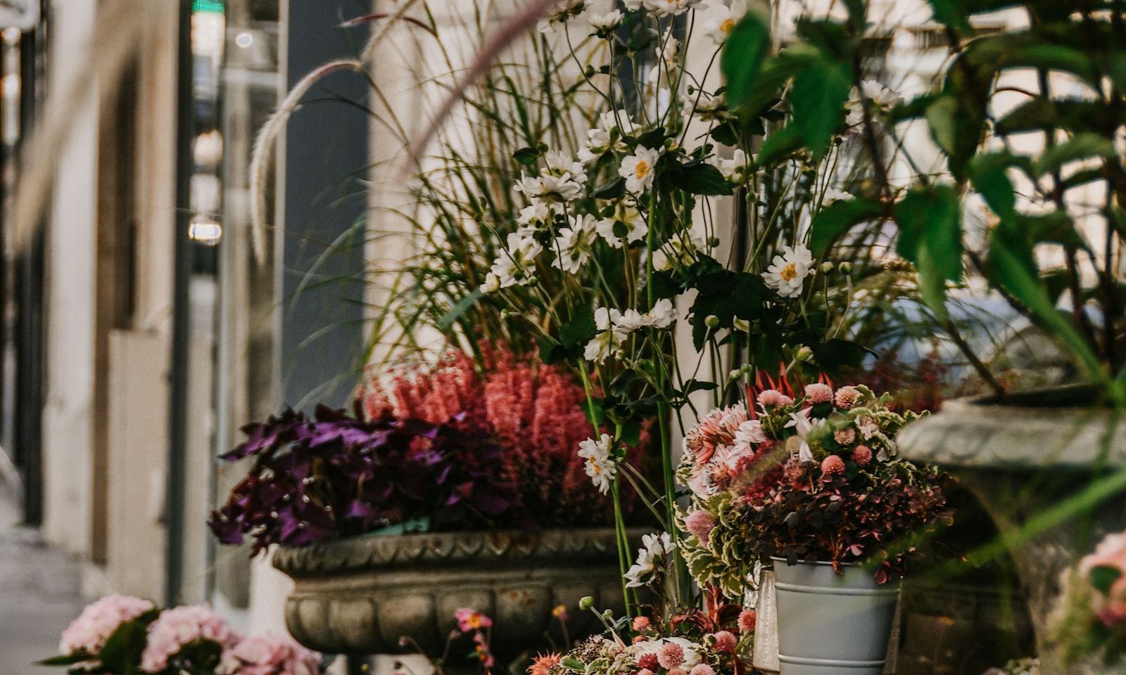 Buckets of fresh flowers outside a little flower shop